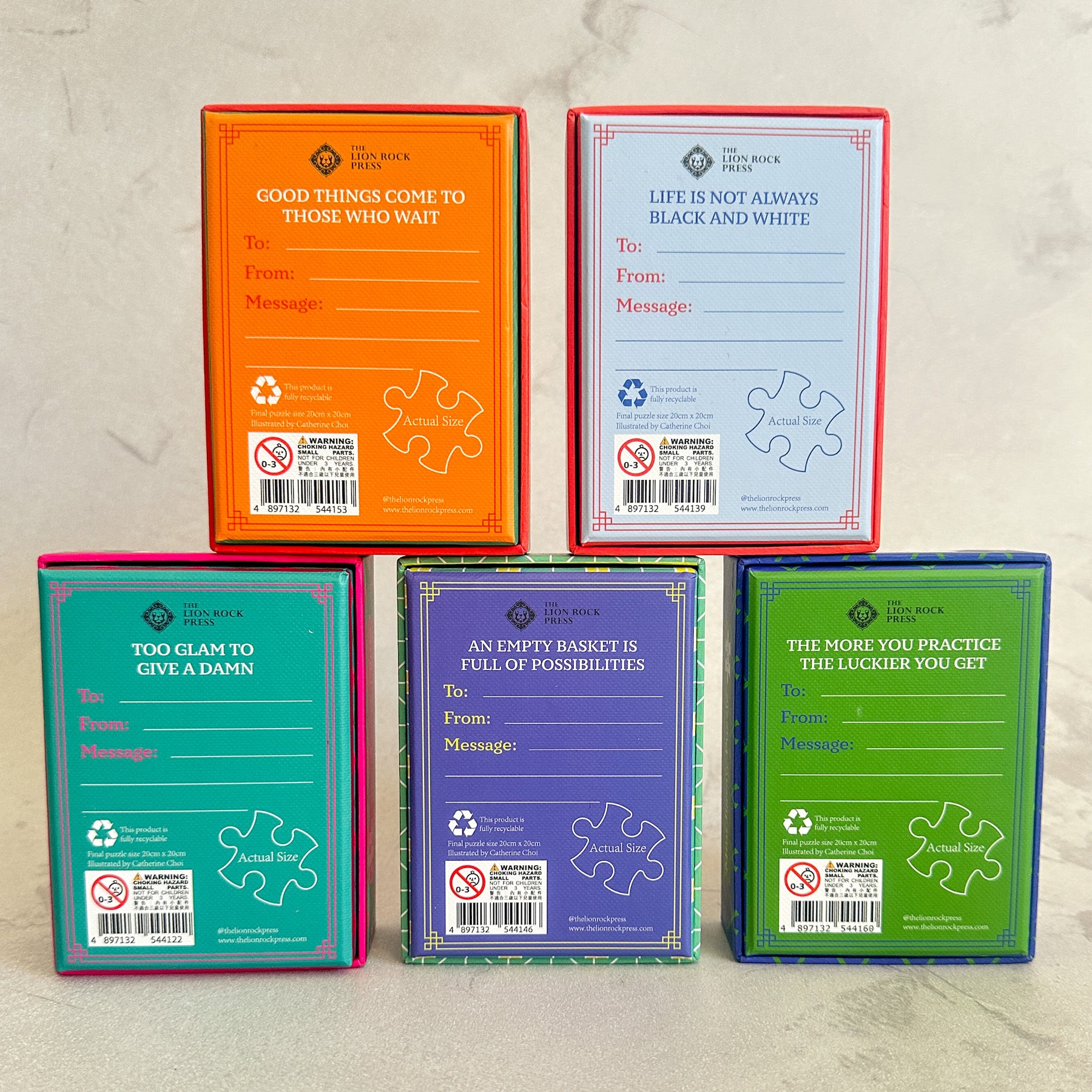 Five puzzle boxes with motivational phrases on a textured surface