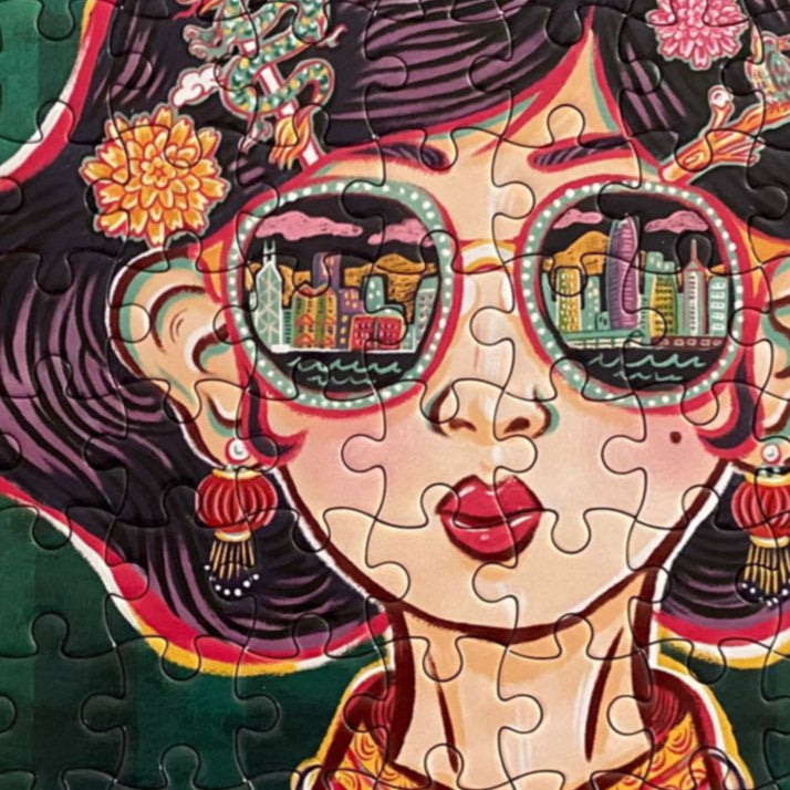 Jigsaw puzzle with a colorful illustration of a woman wearing sunglasses showing the Hong Kong skyline and traditional clothing on a green background.
