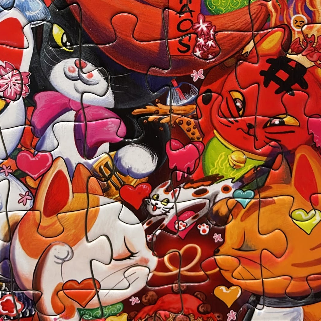 A colorful jigsaw puzzle featuring a dense collage of cartoon cats in various poses and expressions, surrounded by hearts, flames, and abstract decorative elements.