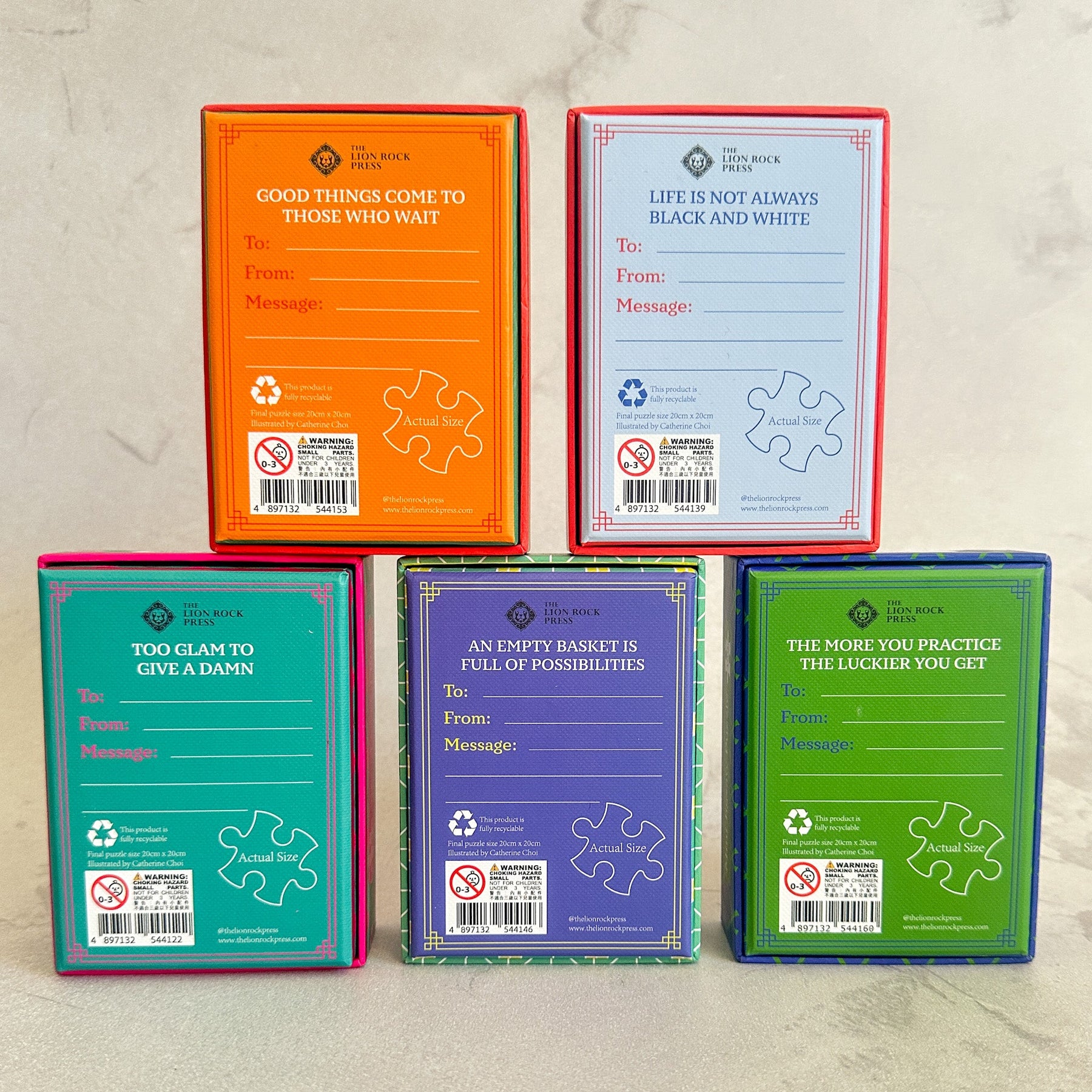 Five puzzle boxes with motivational phrases on a textured surface